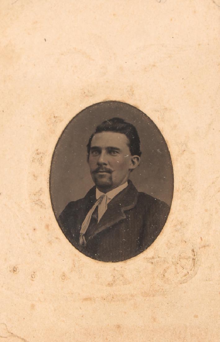 Tintype of Civil War Scout: Tintype photograph of a civil war scout, W. A. Young, in a civil war themed mount with cannons, etc, measuring approximately 2.5 by 3.75 inches overall.