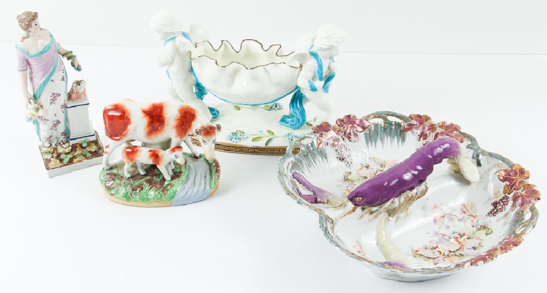 Four Pieces of Miscellaneous Porcelain: Four pieces of miscellaneous porcelain, including a Staffordshire pearlware statue of Hygeia, a Staffordshire statue of two cattle, Royal Saxe lobster themed bowl, and a Moore and Company putti themed