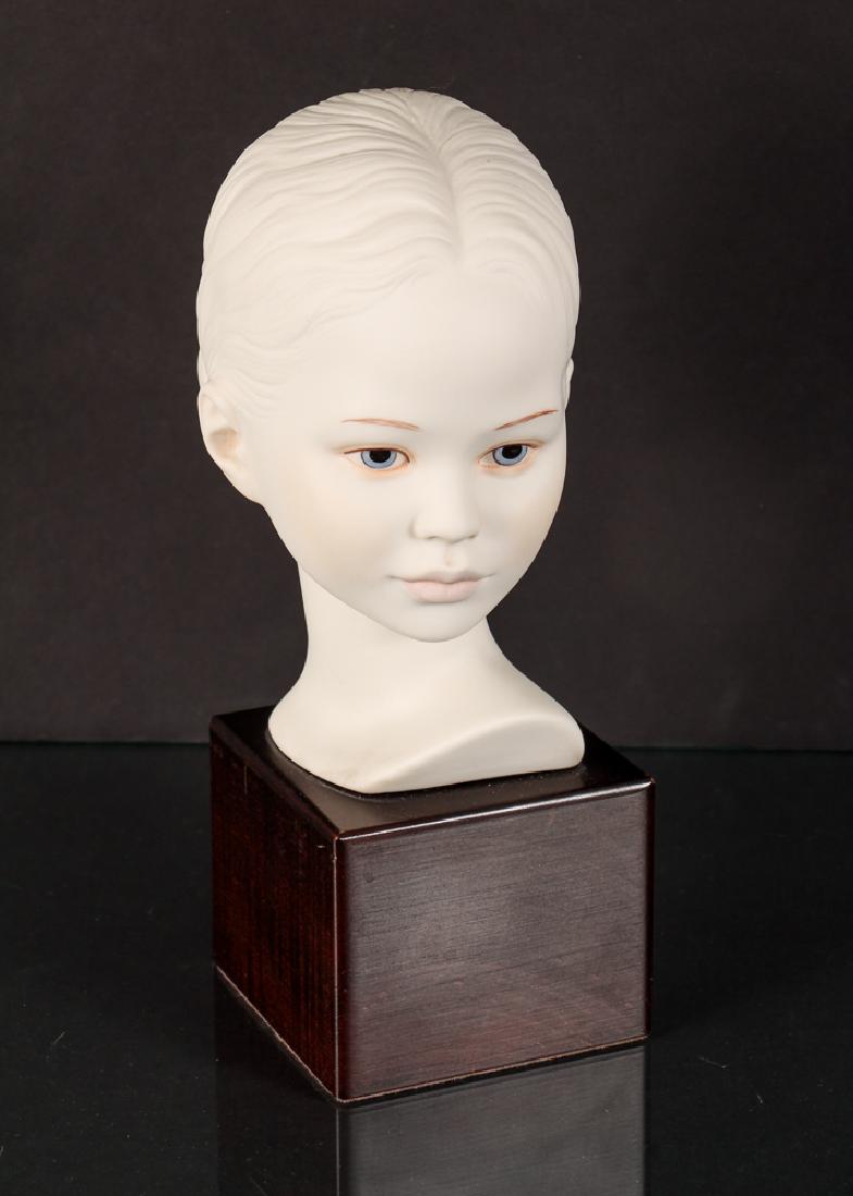 Cybis Porcelain Figurine: Cybis porcelain figurine, of a female head on a wooden base, measuring 10 inches overall.