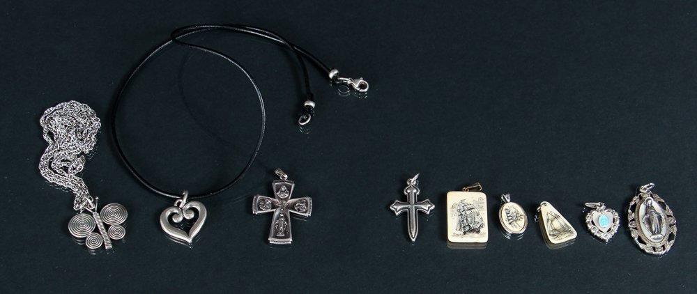 Assorted Sterling Silver Jewelry Inc James Avery: Assorted silver jewelry. Includes 2 sterling silver necklaces, religious medals and 3 scrimshaw bone pendants. Most marked Sterling. Several of the pieces are initialed J.A., James Avery. 1.72 oz.