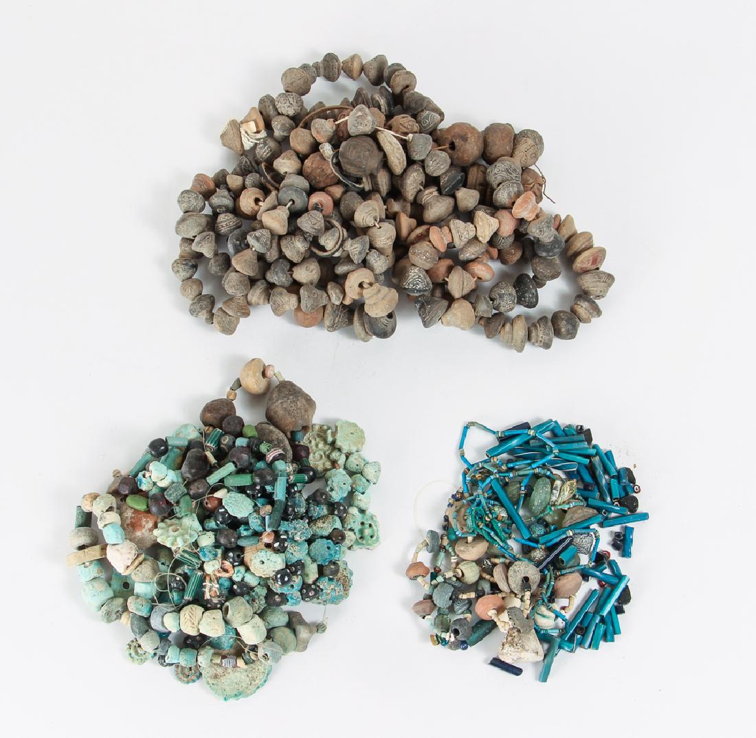 Group of Ancient and Other Beads: Group of ancient beads from Egypt and the middle east and a group of more modern beads from Africa, ranging in size from 1/16 to 2 inches. Provenance: Collection of Ruth Frank.