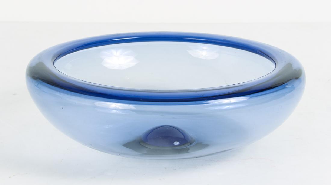 Holmegaard Denmark Glass Bowl Per Lutken: Holmegaard Denmark Glass bowl per Lutken. Art glass bowl in smoky blue. The rim folds in an inch, the bottom center is domed. Measures 4" h, 10 3/4 w. Inscribed on the bottom Holmegaard 17292".