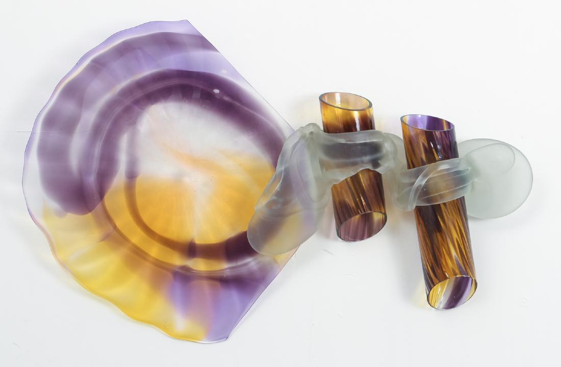 Drew Smith Blown Glass Wall Sculpture: Drew Smith blown glass wall sculpture in tones of yellow, purple and brown. The sculpture consists of a large plate connected to a pair of elongated tubes by a flow of frosted glass. The piece measure