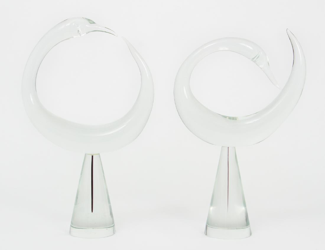 Pair of Modern Clear Glass Swan Sculptures: Two Clear Glass Modern Circular Swan Sculptures on conical pedestals, 2nd half of the 20th Century, 16 x 9.5 inches and slightly smaller, Provenance: The Estate of Hannah Kamin, Pittsburgh, Pa.