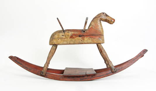 ROCKING HORSE. American, 19th or Early 20th Century: FOLK ART ROCKING HORSE - 19th or Early 20th Century, Pennsylvania, Camp Hill Pa., Carved Pine Rocking Horse with remnants of original paint, original metal collage elements and nail fasteners, 23.5 x