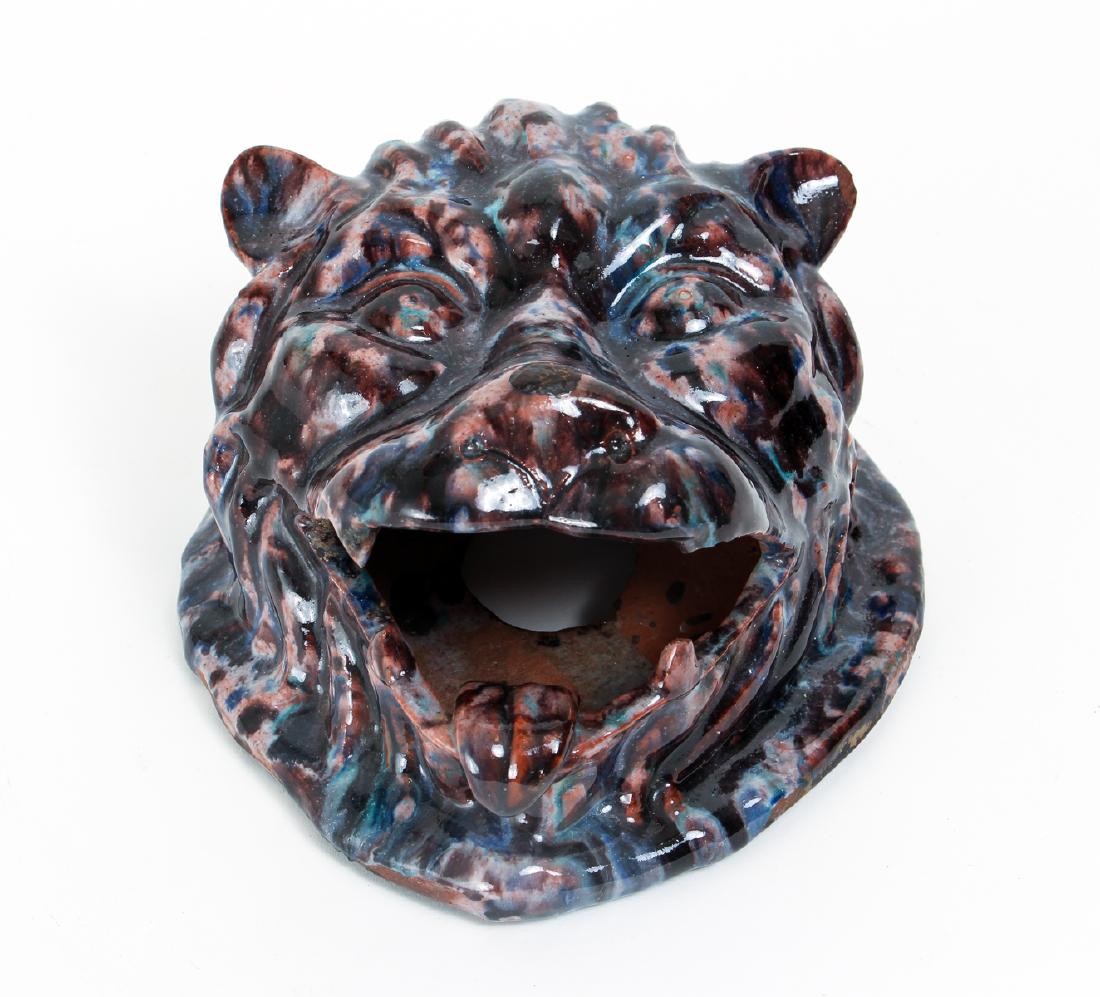 Polychrome Redware Lion's Head Ornament: Polychrome glazed redware lion's head ornament, measuring 8 by 7 by 4 inches. Provenance: Collection of Dr. and Mrs. Howard Tanning, Pittsburgh, PA.
