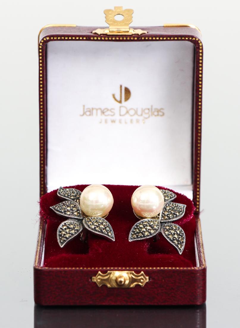 Sterling Pearl and Marcasite Earrings: Sterling, pearl and marcasite earrings. James Douglas designer. Single large pearls with marcasite set leaves. Set on post backs with European closures. 1 7/8" long, 1" wide.