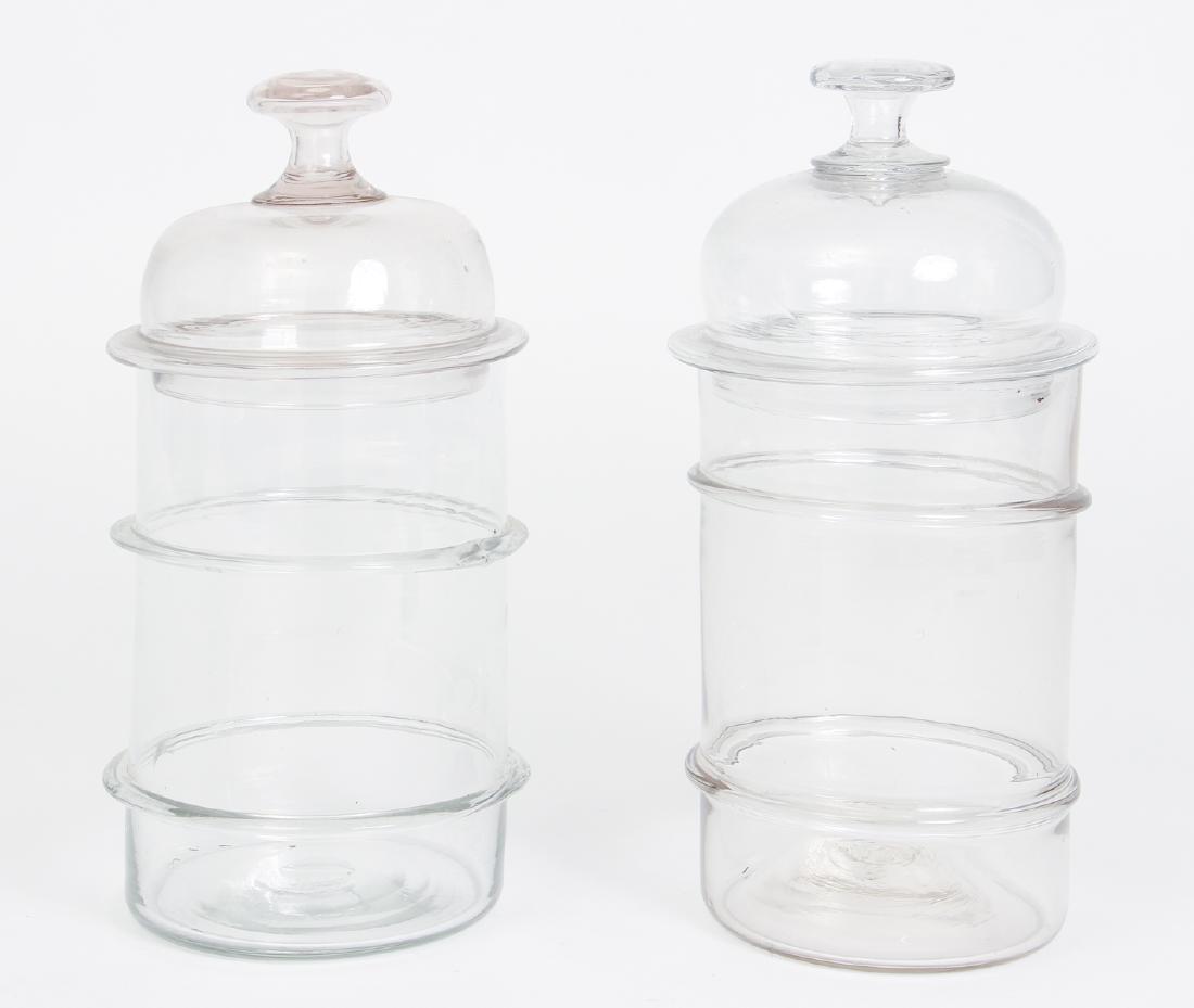 Pair of Antique Ribbed Glass Storage Jars: Pair of antique ribbed glass storage jars, each approximately 12 by 6 inches.