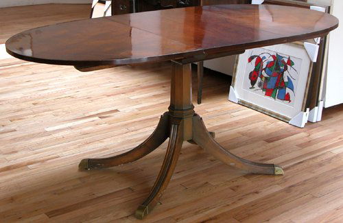 Duncan Phyfe style mahogany extension table: Artist: Title: Duncan Phyfe style mahogany extension table with oval shape top and pedestal base with one leaf (18" wide) Medium: mahogany Dimensions: 50.25 x 36 x 29.5 inches Frame Type: unframed