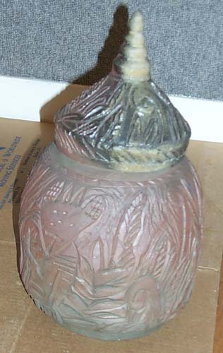Mangus, Kirk: Lidded Carved pot Artist: Mangus, Kirk Medium: Wood fired stoneware Dimensions: With lid 16 x 9 x 9 inches Signature: Incised MAN CVS on underside Condition: Generally good condition