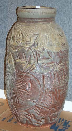 Mangus, Kirk: tall standing carved pot; Large carved clay Vessel Artist: Mangus, Kirk Medium: Wood fired stone ware Dimensions: 29 x 16 x 16 inches Signature: Incised MAN around base Condition: Generally good condi