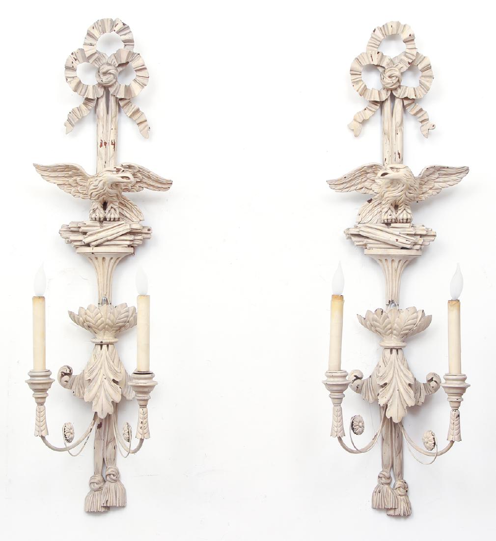 Two Eagle Themed Wood Wall Sconces: Two eagle themed wall sconces, two lights each, with two concealed lights, painted wood measuring 43 by 12 by 12 inches.