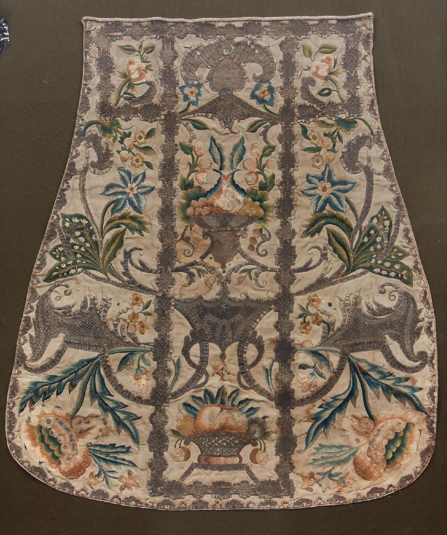 ANTIQUE VESTMENT framed in two pieces front and back: very intricate embroidered Vestment framed into two shadow boxes, including silver thread , showing flowers and fruit filled compotes surrounded by an elaborate arabesque, framed in two shadow box fra