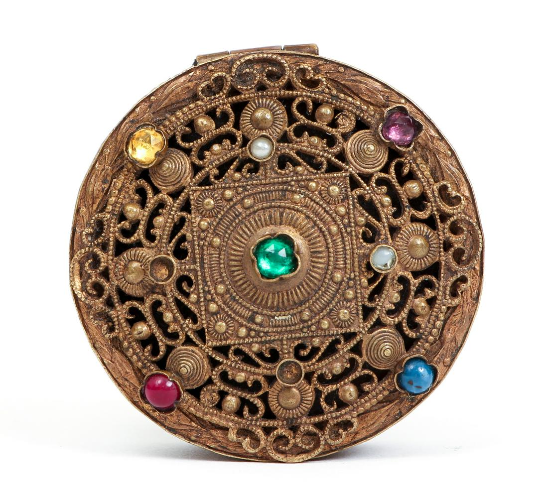 Gilt Bronze Austrian Pill Box: Gilt bronze Austrian pill box with various faux gemstones (two are missing), with mirror on inner lid, .5 x 1.75 inches.