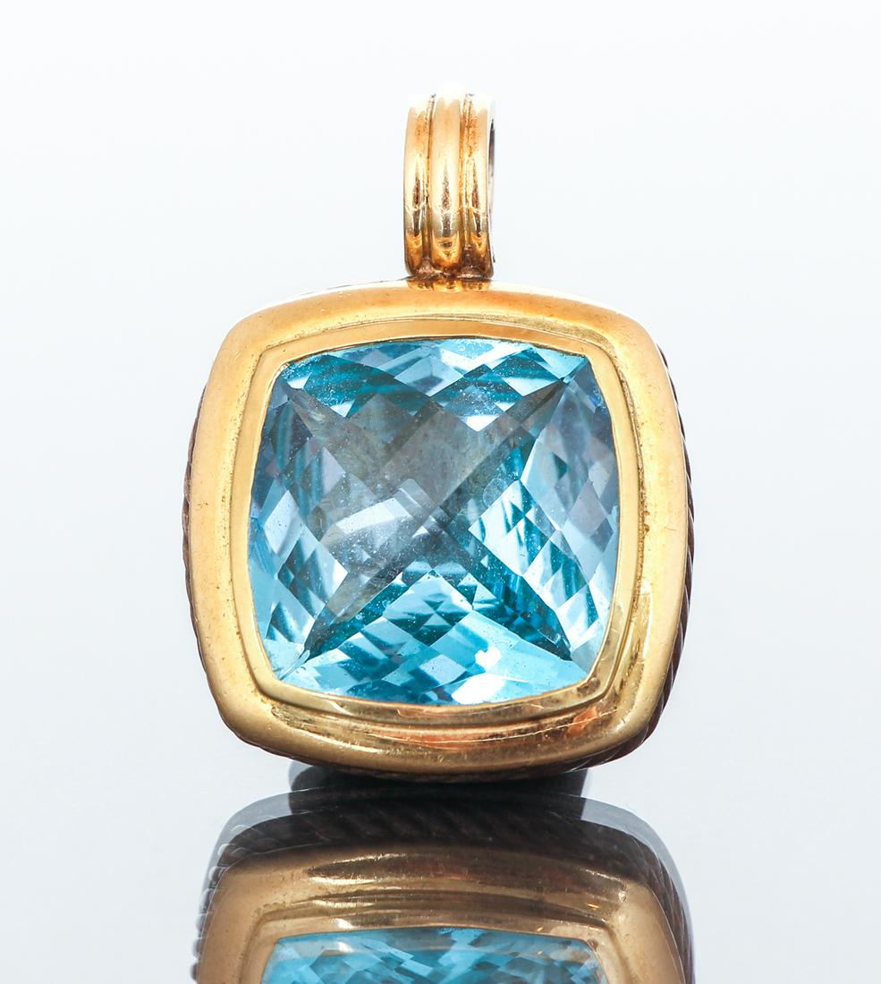 David Yurman Blue Topaz Sterling 18k Gold Pendant: David Yurman sterling and 18K gold pendant with a blue topaz stone measuring 20 by 20 by 7.5 mm approximately.