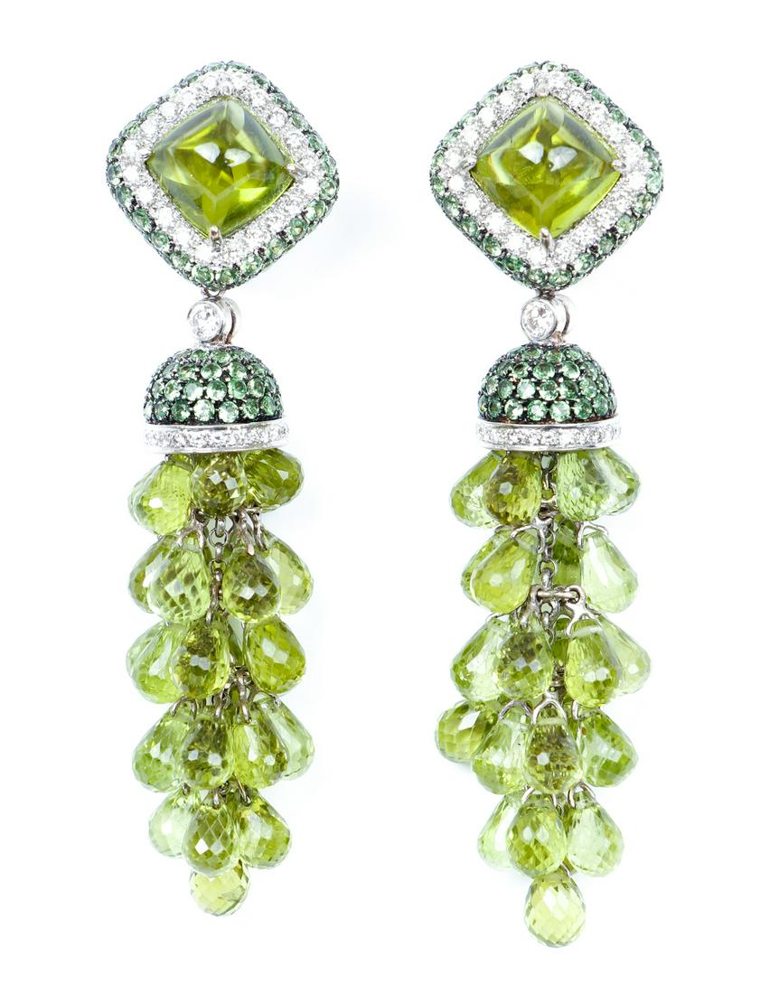 Pair 18 K Gold Diamond and Peridot Earrings: Pair of earrings each featuring an approximate 3 carat peridot surrounded by diamonds and other pave set peridot, each with a removable suspension of peridot and diamonds featuring a cluster of briole