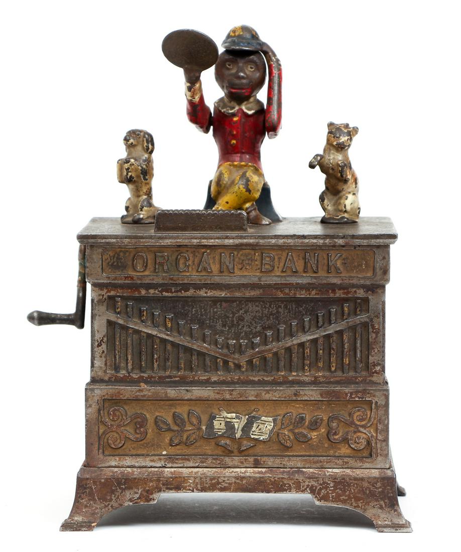 Organ Mechanical Bank: An organ mechanical bank, which is also a music box. The mechanism of the bank and the music works perfectly. The colors are original and preserved. 8"H x 5.5"L.