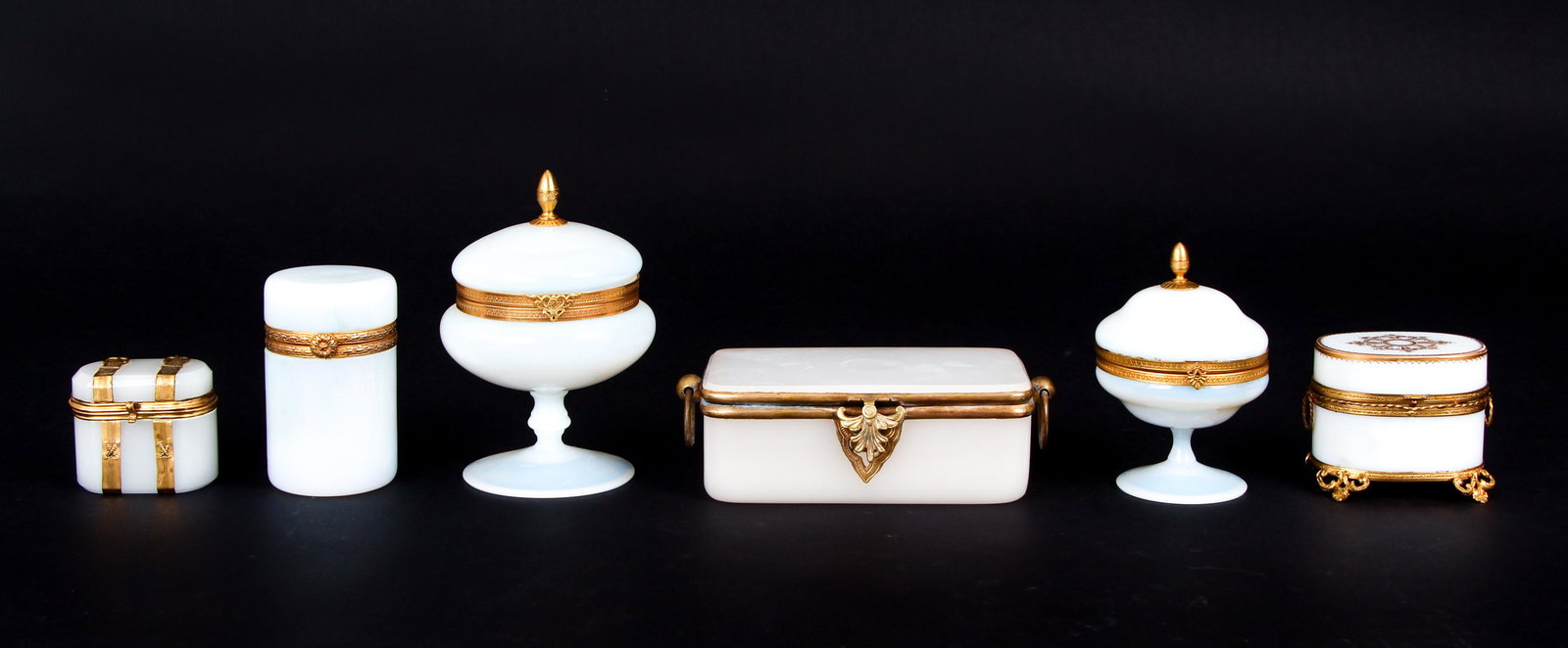Six Opaline Boxed Including Perfume: Six opaline boxes, including one in the form of an antique trunk the interior fitted with two perfume bottles, tallest 6 1/2 inches. Provenance: mostly Sallea Antiques, New Canaan, CT.