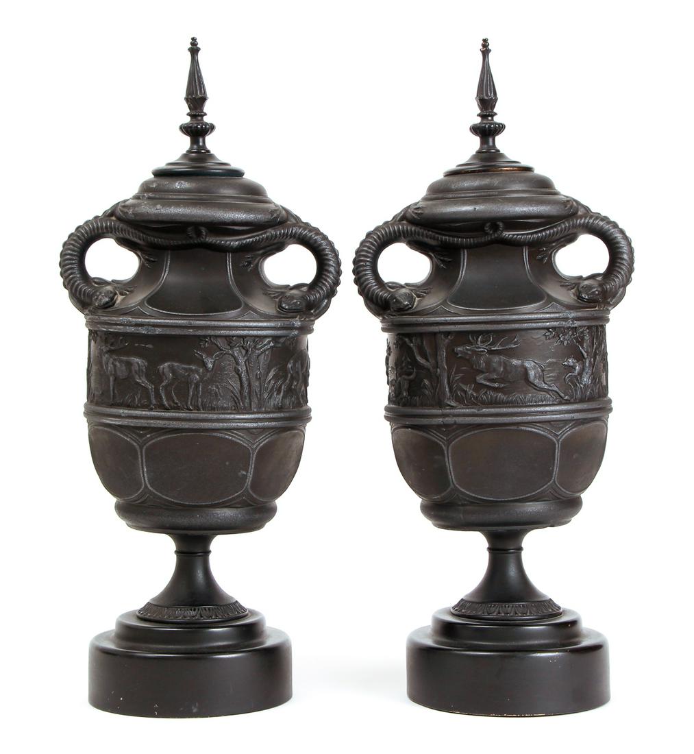 Pair of Victorian Graphite Urns: Pair of Victorian graphite urns, featuring lizard or salamander handles, with a frieze depicting deer in a landscape being chased by a fox, with metal mounts, 19 1/2 inches.