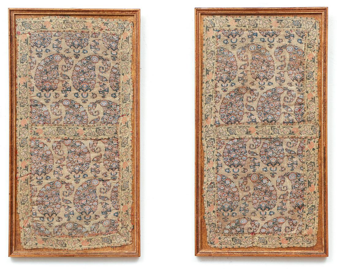 Two Framed Middle Eastern Fabric Fragments: Two framed fabric fragments, possibly Arabic or Indian, with woven or embroidered colored silk paisleys on a gold thread background, each 15 by 7 inches, in gold frames measuring 16 by 8 1/2 inches.