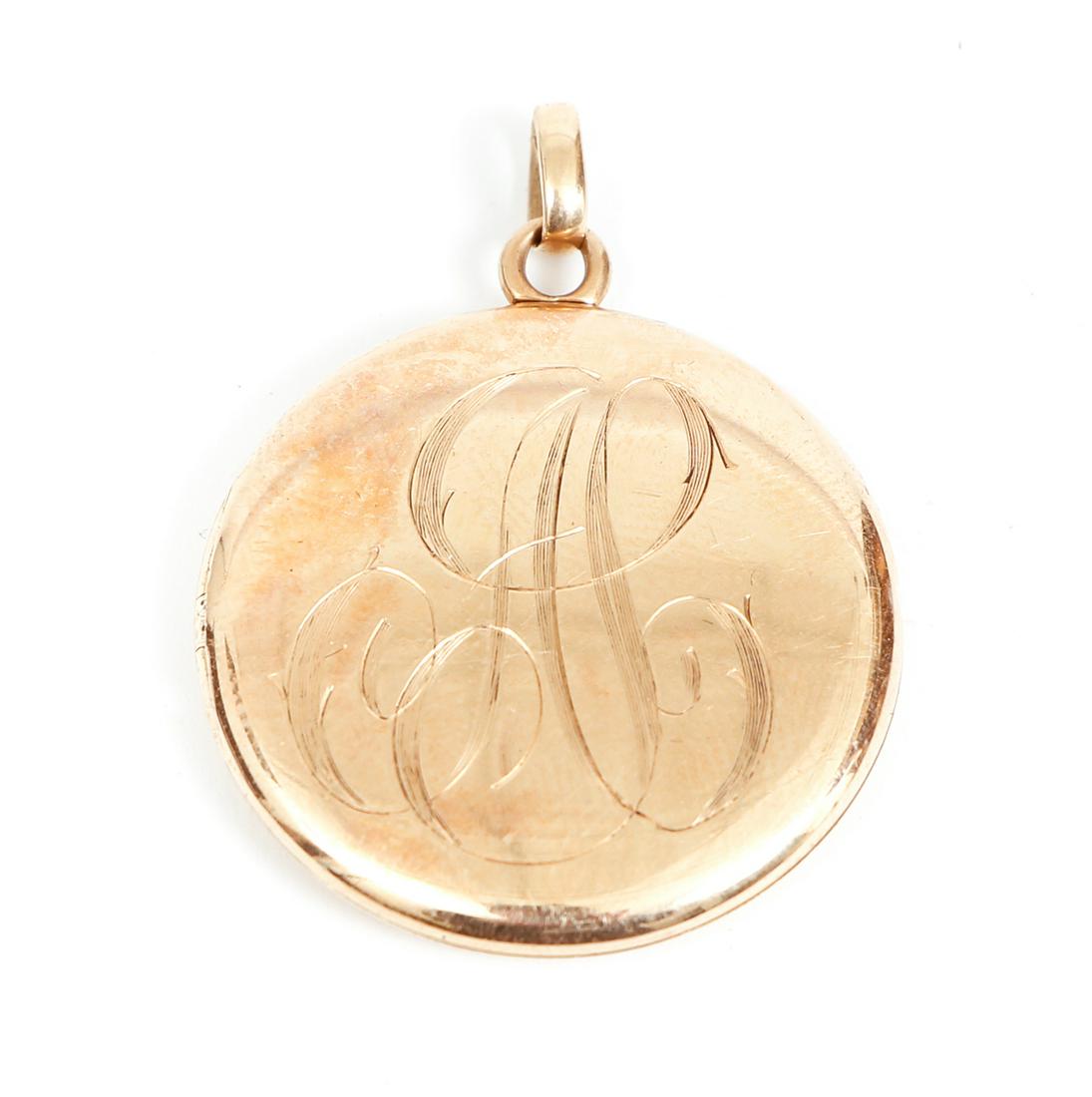 Antique 14K Gold Locket: Antique 14K gold locket. Initials engraved on either side. The inside of the locket is marked 14K. With gold bale. Measures 1 1/4" diam. Approx. 7.7 grams.