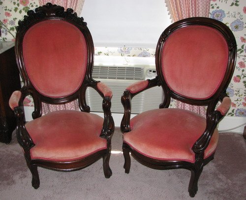 Pair of Pink Upholstered Victorian Low Armchairs: Artist: Title: Pair of Pink Upholstered Carved His and Hers Victorian Low Armchairs Medium: mahogany Dimensions: 43.5 x 33 x 27 inches (larger chair)