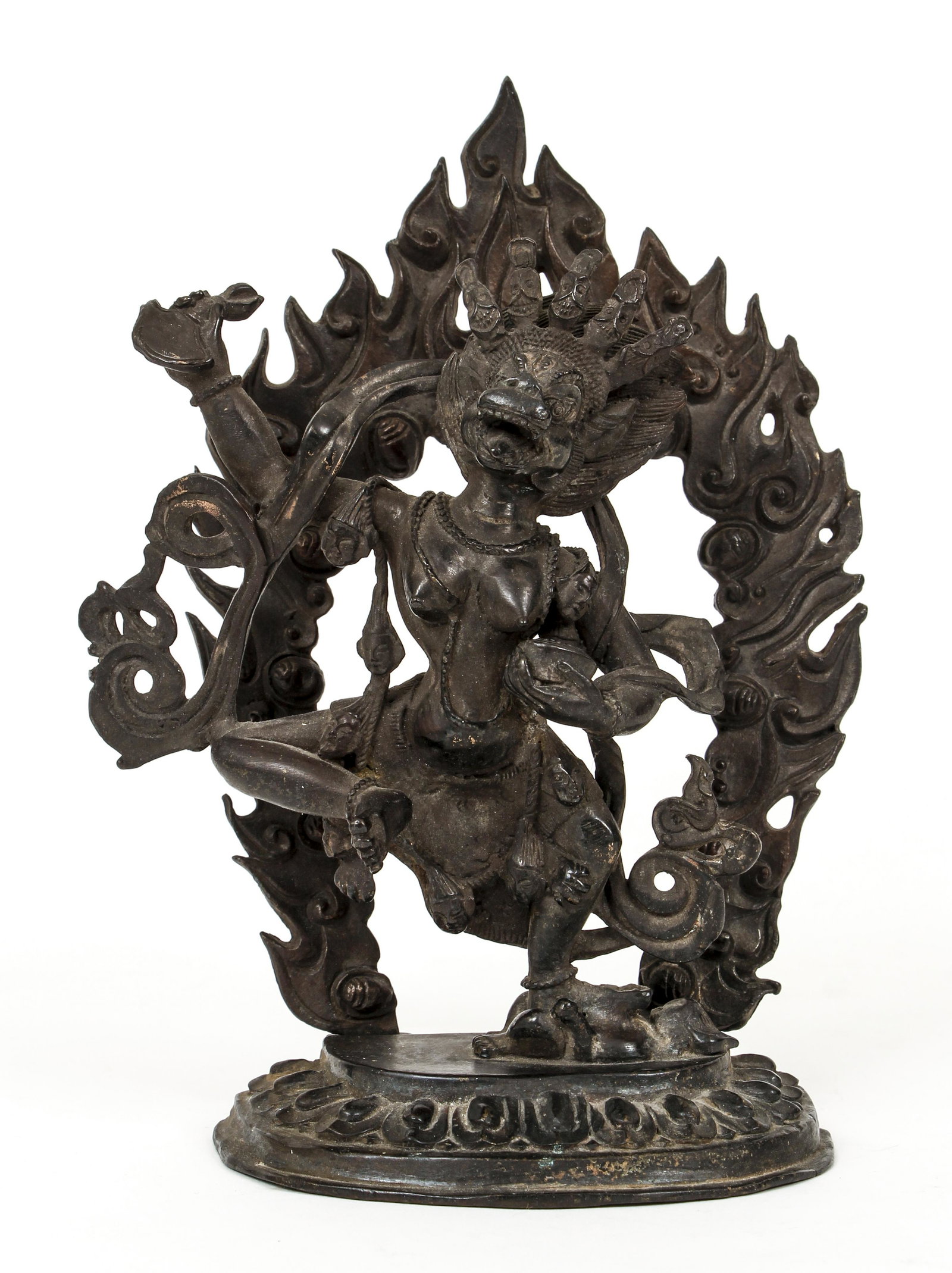 Tibetan Bronze Fierce Dakini: Tibetan Bronze showing a Fierce Lion Headed Dakini, c.20th century, 7 x 5.5 inches, central figure on one foot, skull cup in hand, atop lotus base, with flaming aureole.