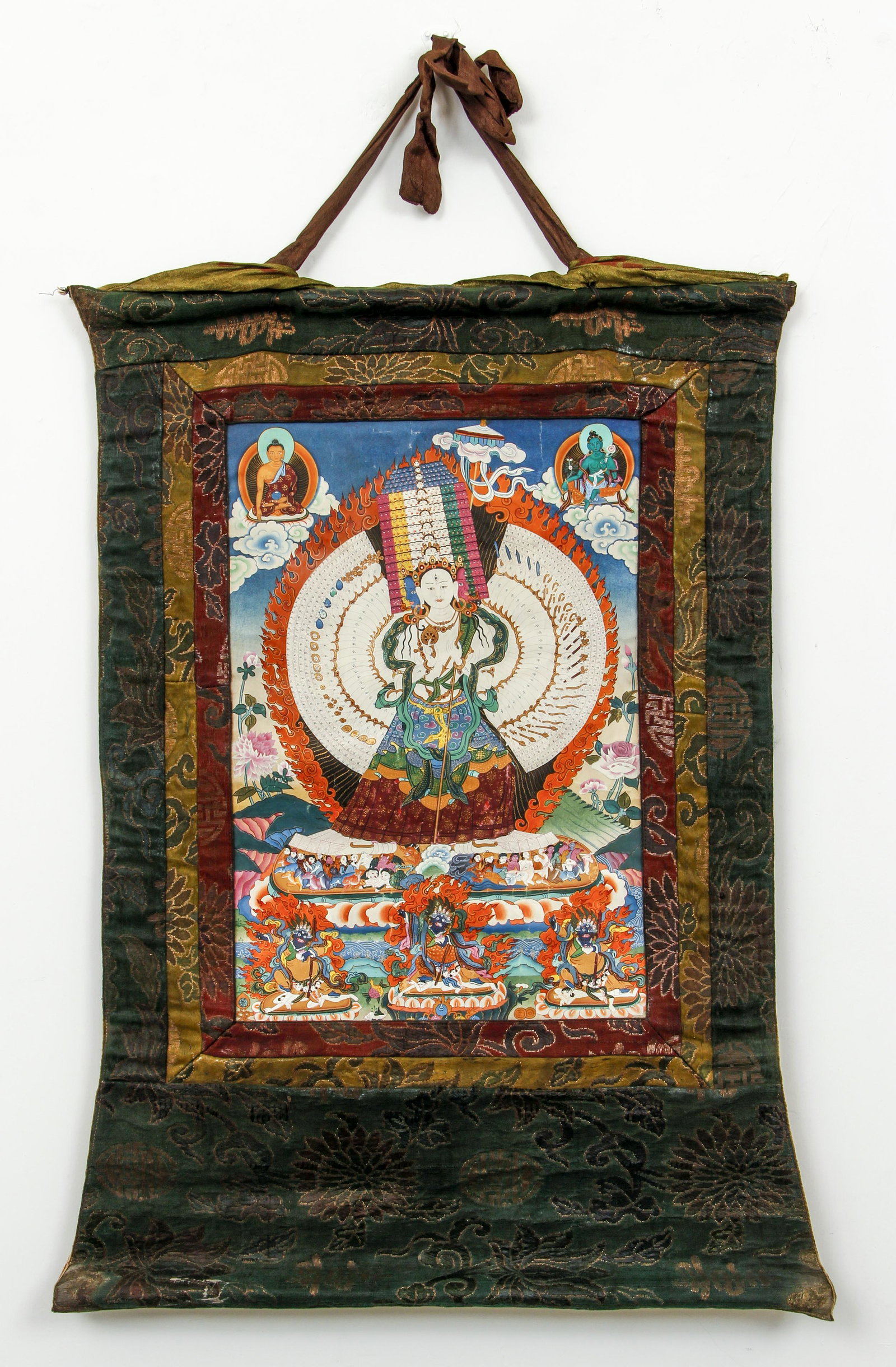 Tibetan Thangka Vajra Ushnisha Sitatapatra Silk Brocade: Thangka of Vajra Ushnisha Sitatapatra (Ushnishhasitatapatra), gouache on paper, in original silk surround, 20th century, thangka 17.5 x 12 inches, with silk surround 29 x 22 inches, central figure in 