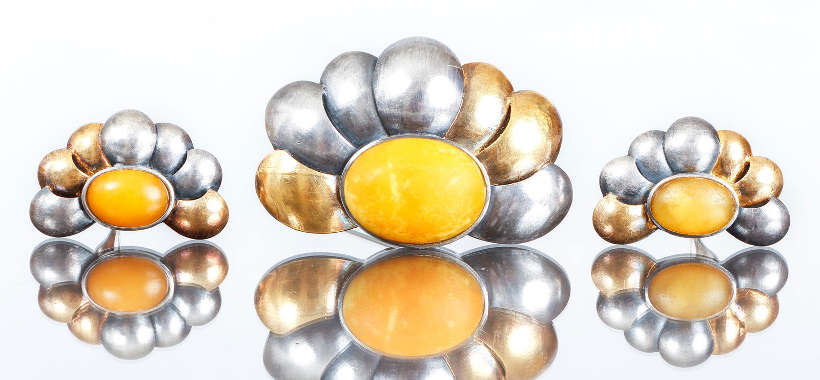 24K Gold and Sterling Jewelry Set: 24K gold and sterling pin and earring set. Abstract floral pin and clip earrings. The pieces are bezel set with single yellow gold hardstones, possibly amber? Marked, Ag 925 24K. The pin measures 2 1/