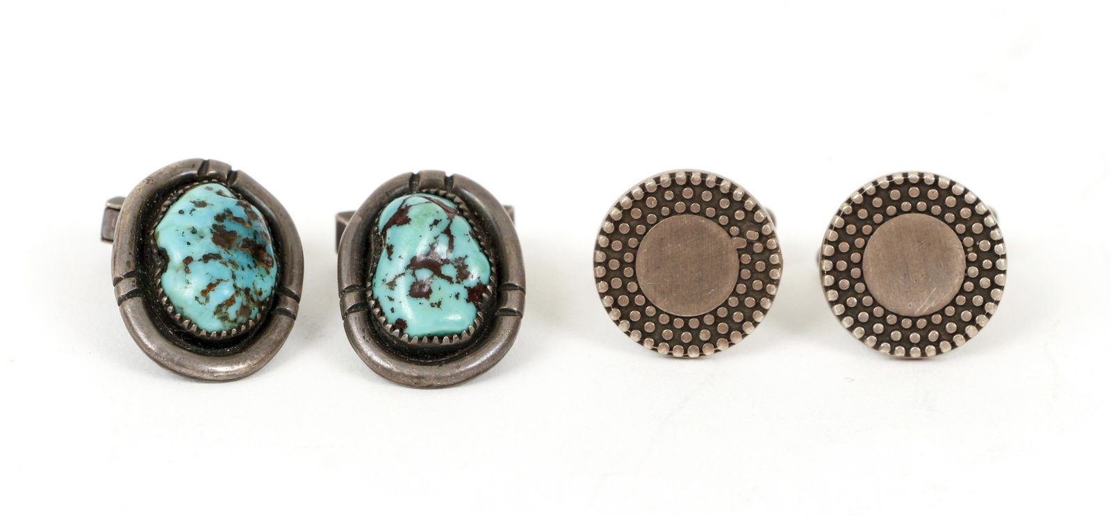 2 Pair of Sterling Cuff Links: 2 Pair of sterling cuff links. One pair is bezel set with tumbled turquoise stones, oval in shape. The cufflinks measure 1" long, 1/2" wide, marked "sterling". The second pair is round with bold milgr