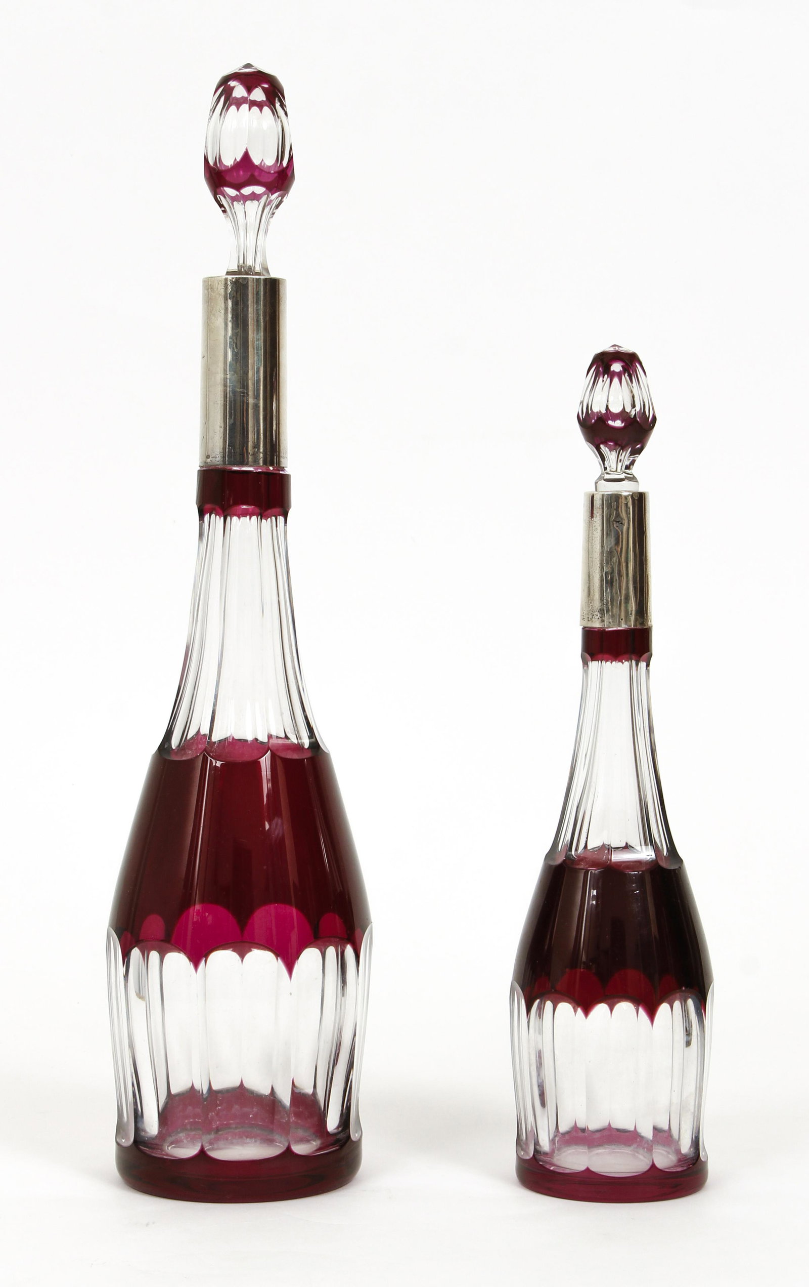 2 Cut to clear Bohemian Decanters with 800 silver necks: Bohemian cut to clear Decanters with 800 silver neck supports and matching stoppers, 17.25 inches tall and shorter