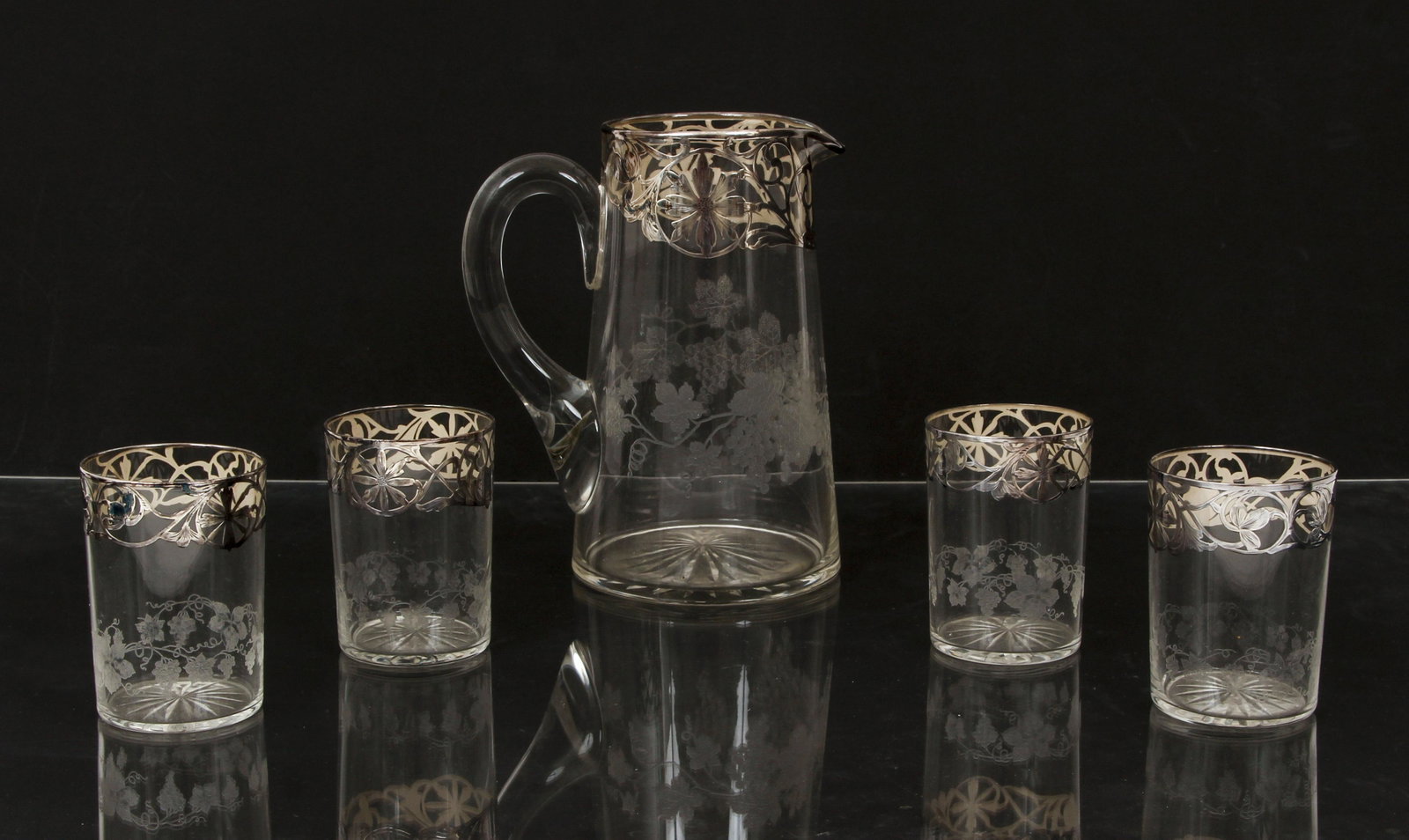 Pitcher and 4 tumbler set with sterling overlay: Sterling overlay vines and flowers with hand engraved grape vine decoration set of four tumblers 3.75 inches tall and pitcher 8.4 inches tall, early 20th Century