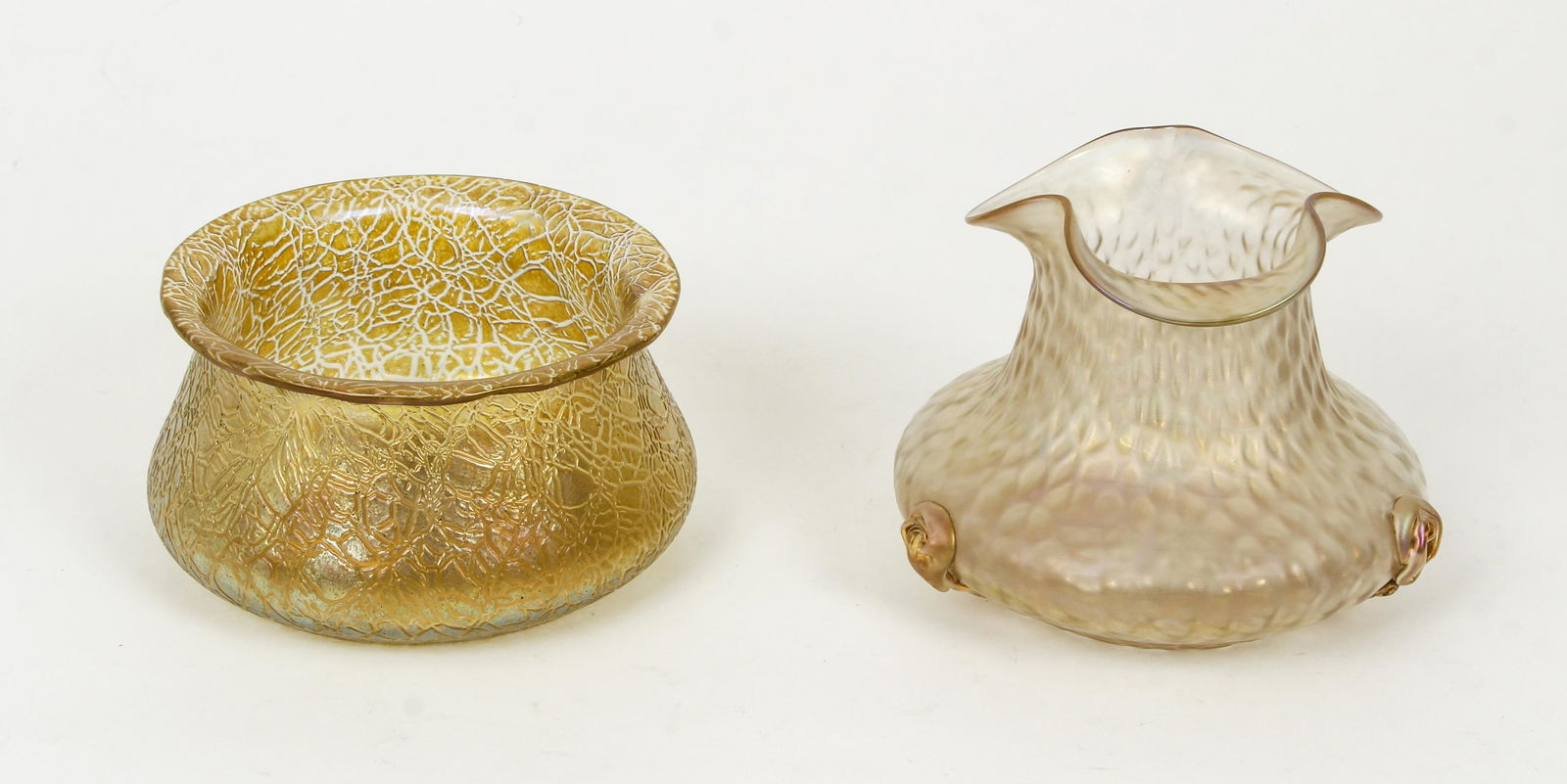 Pair Loetz Style Iridescent Art Glass Vases: Pair of Loetz style Iridescent Art Glass Vases, unmarked, one with three floral accents to lower rim, sizes 5 inches tall x 6 inches wide and 3.75 x 6.5 inches. Provenance: The Estate of Charles M. Di