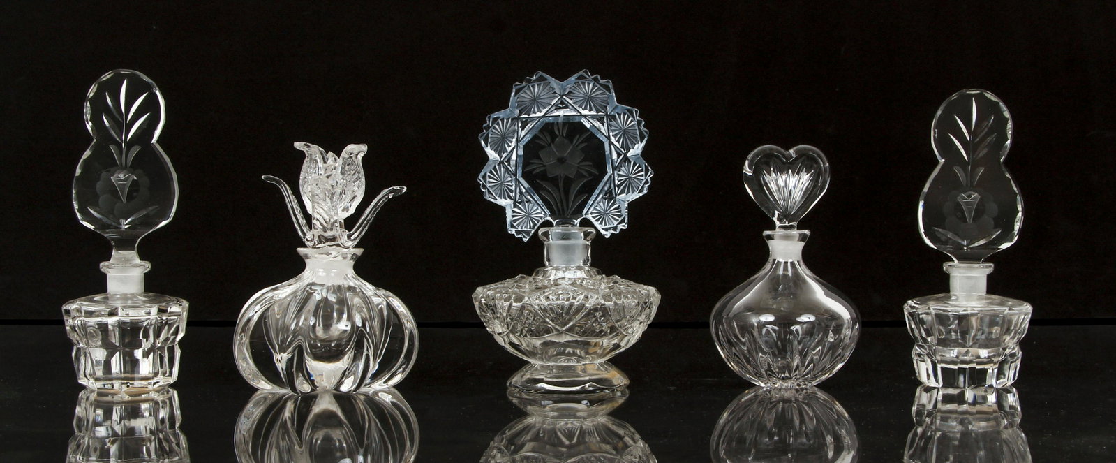 Lot of 5 Medium Crystal Perfume Bottles: Lot of 5 Medium Crystal and Glass Perfume Bottles, tallest one 5.5 inches, all stoppers included, two with Irving Rice stickers, one with Morlee sticker, one Marquis by Waterford.