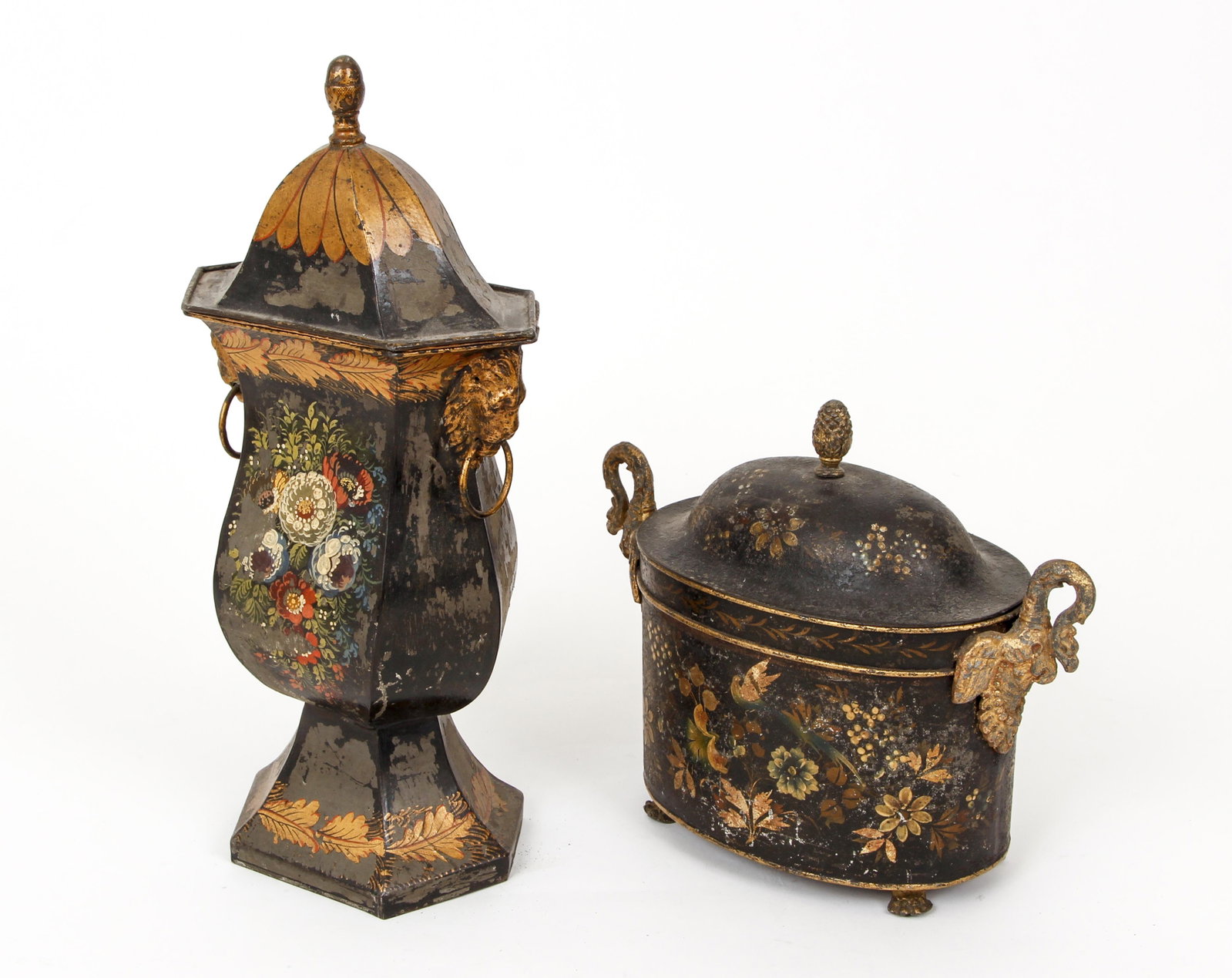 2 lidded tole ware pieces: Lidded Vase with Lions Head Handles 14 inches tall and Oval shaped Box with elongated Swan handles measuring 8 x 10 inches, both with flower and vine painted decorations