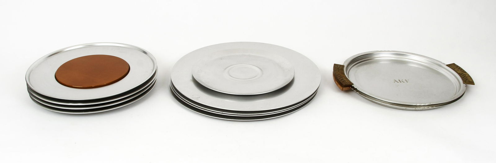 11pc Kensington Ware Large Circular Trays Zodiac: 11 piece lot of Kensington Ware, aluminum, maker's mark etched to bottoms, large circular trays, includes: 4 Zodiac trays with brass center design, 4 Cheese and Cracker sets with wood inserts, 2 handl