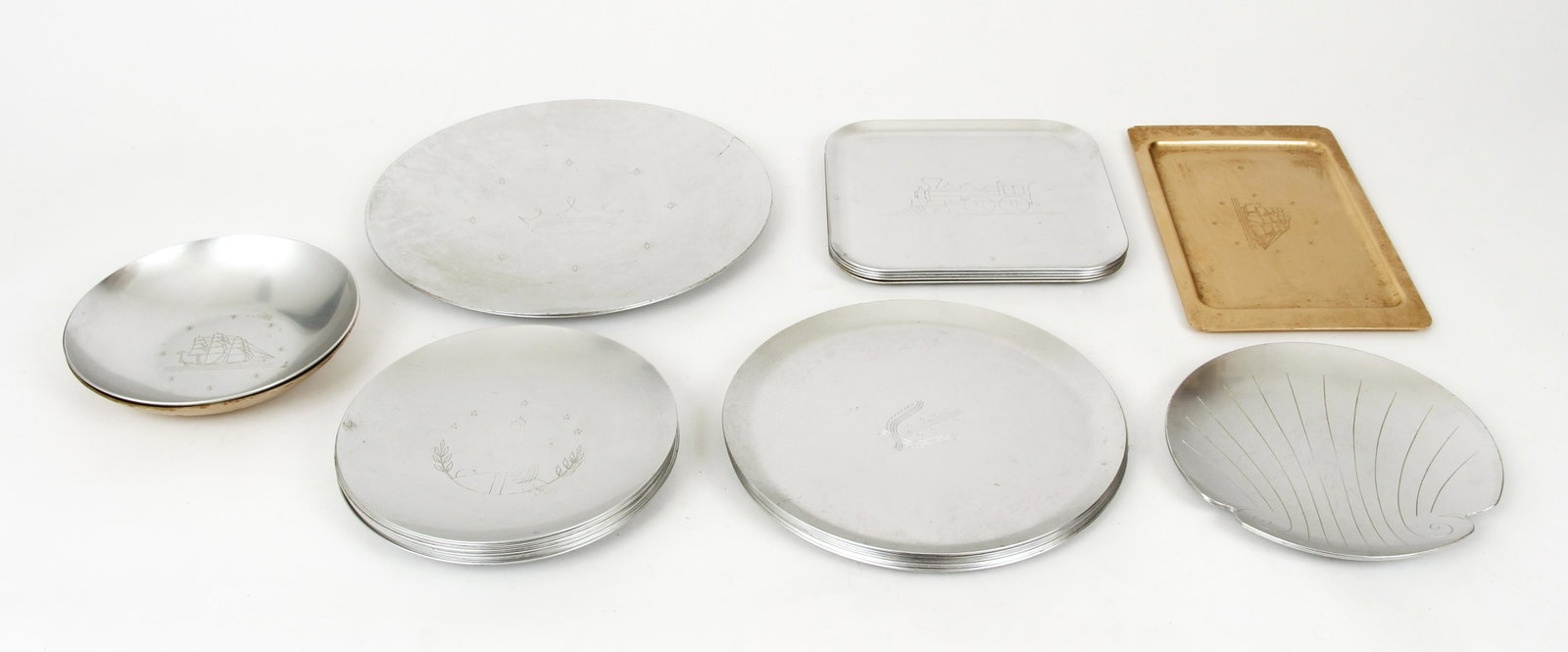 28pc Kensington Ware Plates Trays and Dishes: 28 piece lot of Kensington Ware, aluminum, including dishes, plates and trays, all with etched design in center and Kensington logo on base, includes 2 large trays, 7 dinner plates, 9 lunch plates wit