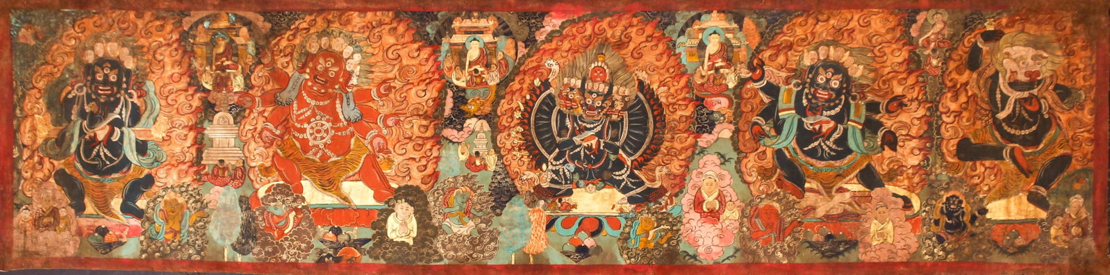 Large Tibetan Thangka 19th century Fierce Deities: Thangka with Vajrapani, Hayagriva, Yamantaka, Malakal a, Singhamuka and many other figures and deities, Tibet, 19th century, gouache on cotton, writing in red paint on reverse, 25 x 99 inches, five ce