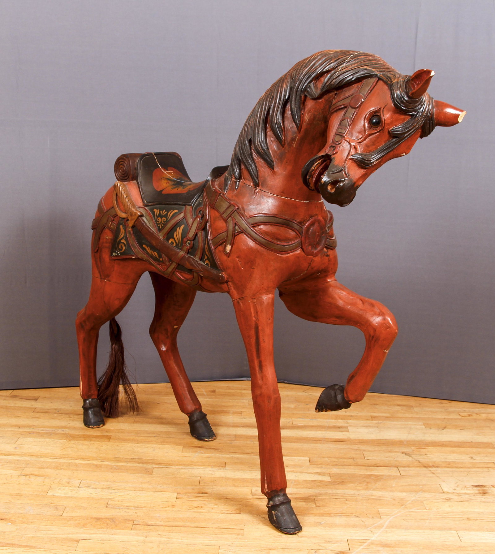 Large Antique Carved Painted Wooden Horse: Antique Carved and Painted Wooden Horse, early 20th century, 47 x 43 x 12 inches, horse hair tail, beautifully rendered and painted saddle and scabbard.