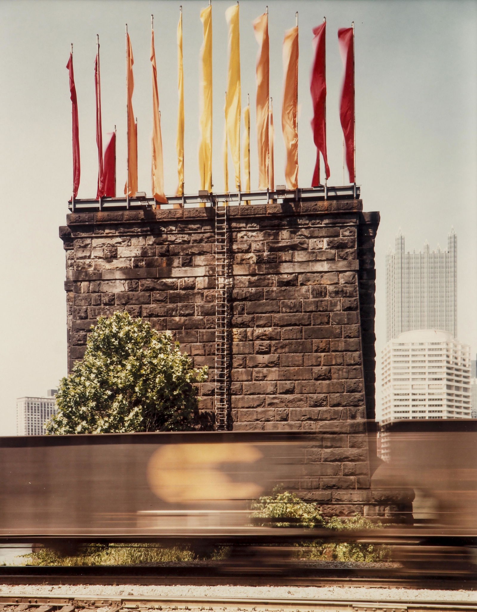 Joel Meyerowitz 1984 color photo Flags at TRAF: Meyerowitz, Joel (American, born 1938), Untitled (Jody Pinto Flag Installation on Pointe Bridge Piers from 1984 TRAF), 1984, chromogenic print, 9.6 x 7.5 inches, sheet 14 x 11 inches, framed measuring