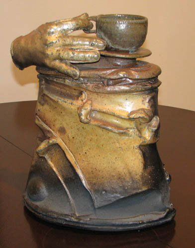 Brad Schwieger Lidded Vessel with hand and tea cu: Artist: Schwieger, Brad (Contemporary American) Title: Lidded Vessel (Attached lid w/hand and tea cup) Date: 1992 Medium: glazed ceramic Dimensions: 15 x 12 x 8 inches Signature: Incised with s