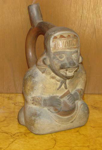 Peruvian Moche III stirrup spout fox bottle: Title: Moche III stirrup spout fox bottle, north coast of Peru circa AD300-500 Medium: sculpted and incised painted ceramic Dimensions: 9 x 7 x 5 inches Provenance: Ruth Frank Collection (With spec