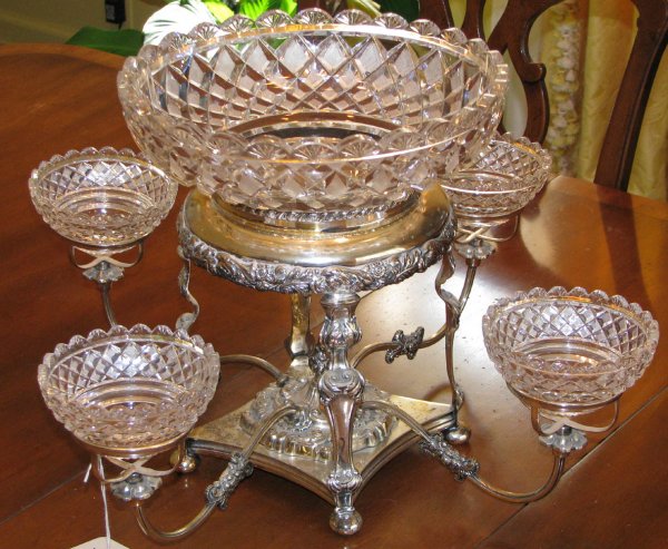 English 19th Cent Silver plate & Crystal Epergne: Title: English Victorian 19th Century Silver plate and Crystal Epergne, upper half circular shape with flared gadroon rim which encloses a circular miter cut scalloped rim crystal and quilt decorated 
