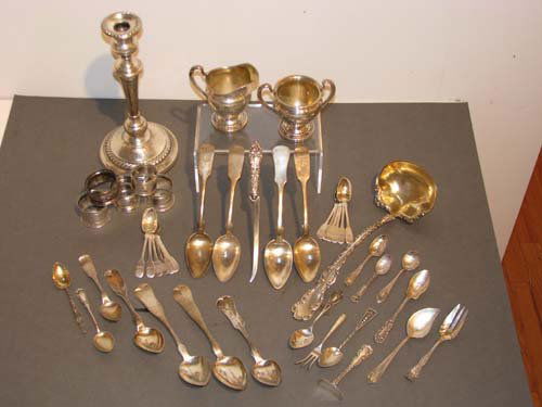 Assorted Sterling serving utensils with Candlestic: Title: Assorted Sterling serving utensils including 2 creamers, assorted silverware, ladle, napkin rings and weighted candlestick Medium: sterling silver Dimensions: 36.5 ozt plus weighted candlest