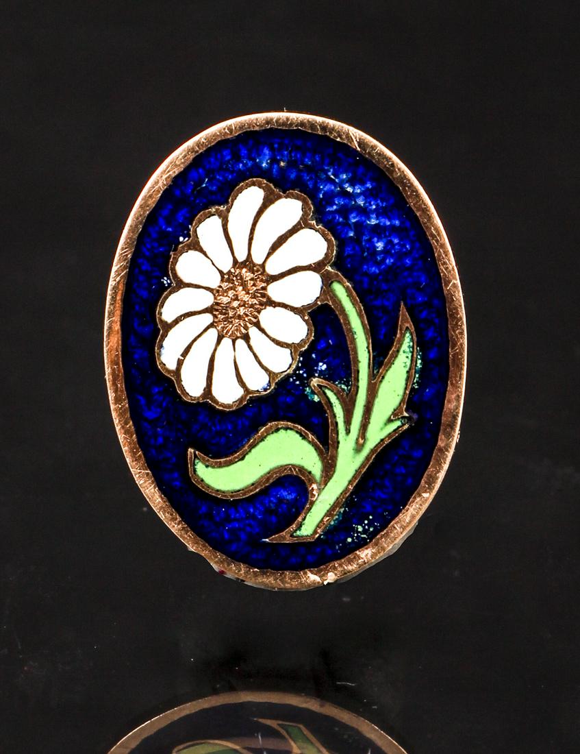 12K Antique Enamel Floral Pin: 12K yellow gold antique floral pin. The oval pin is decorated with a curling white daisy, green leaves and stem on a deep blue field. Engraved on the back "Elise Shaw 93-96". Measures approx. 13/16" x