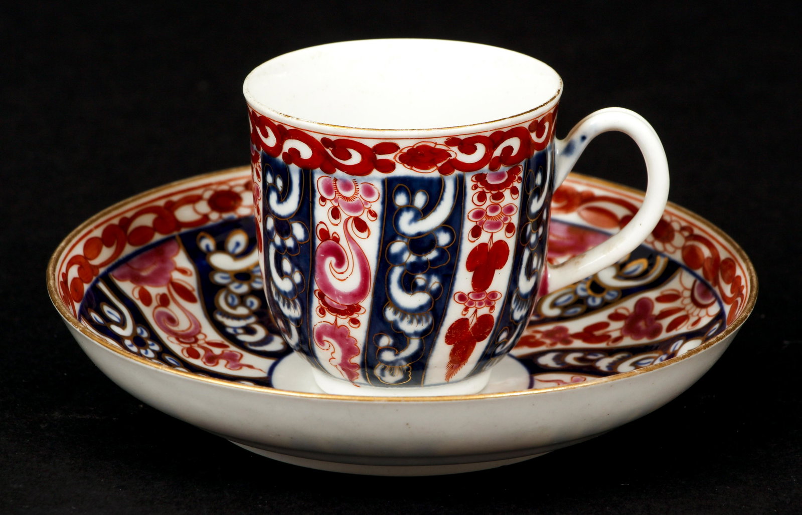 Worcester Teacup and Saucer c.1800 Queen Charlotte: Worcester Porcelain Teacup and Saucer in the Queen Charlotte Pattern, c.1800, possibly earlier, the teacup with blue maker's mark (Xs in a Square) on base, and the saucer with the famous blue crescent
