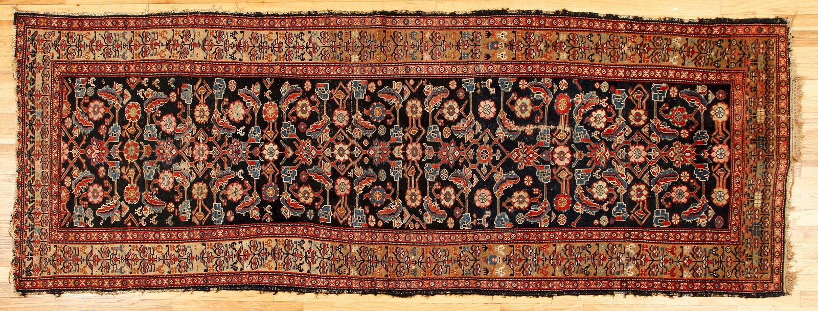 Antique Persian Hamadan Rug: Antique Persian Hamadan Rug with stylized floral motifs against a deep blue ground, 41 x 110 inches.