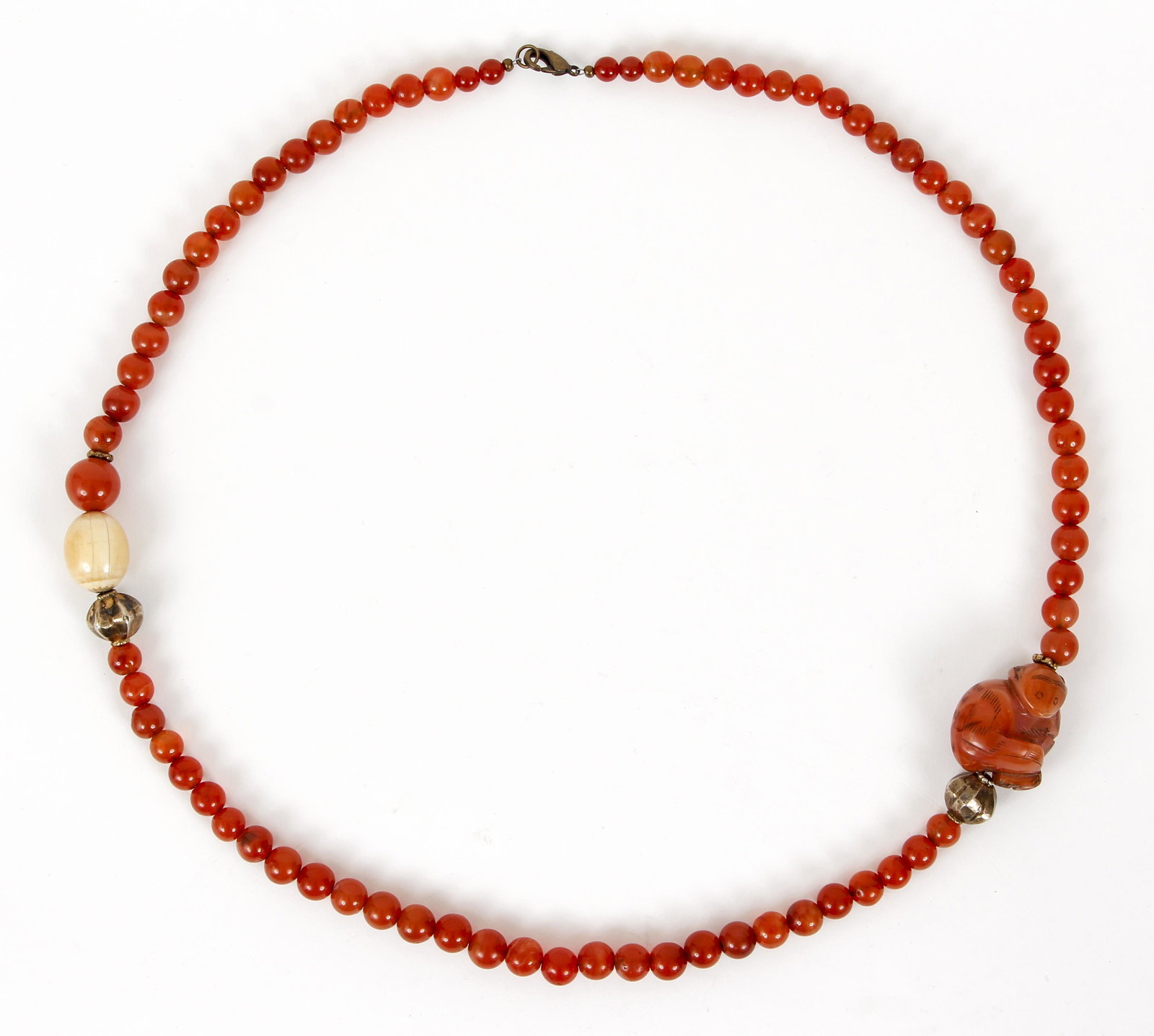 Ruth Frank Amber Bead Necklace: Ruth Frank beaded necklace, Amber tone beads with a carved stone monkey, bone and silver beads. Finished with a lobster claw clasp. Measures 35" long.