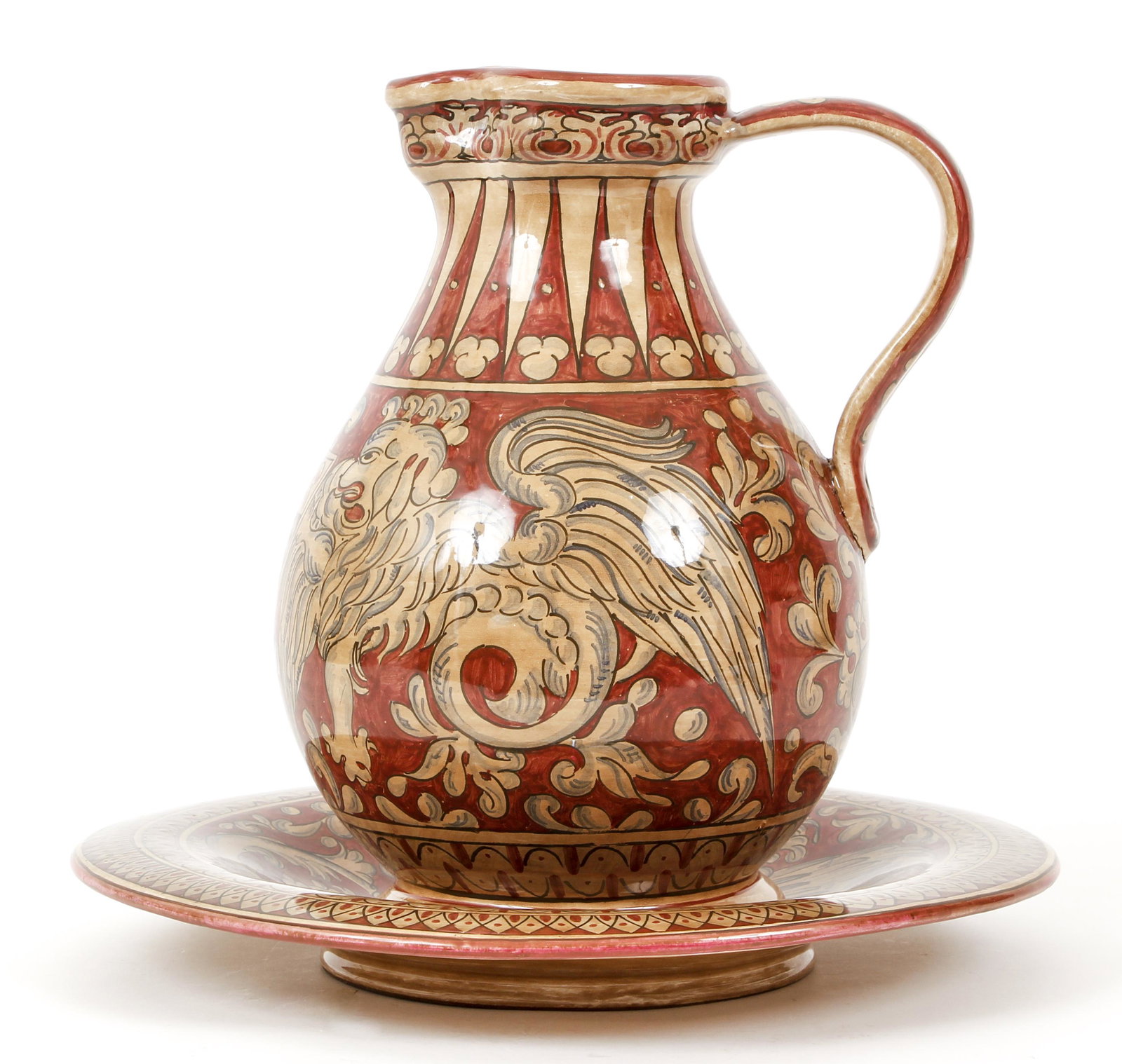 Magnanelli Gubbio Pitcher and Underplate: Magnanelli Gubbio Pitcher and Underplate glazed coat of arms and with flanking pair of medieval dragons or griffins flanking a shield, Pitcher 12 inches tall, underplate 14 inches in diameter.