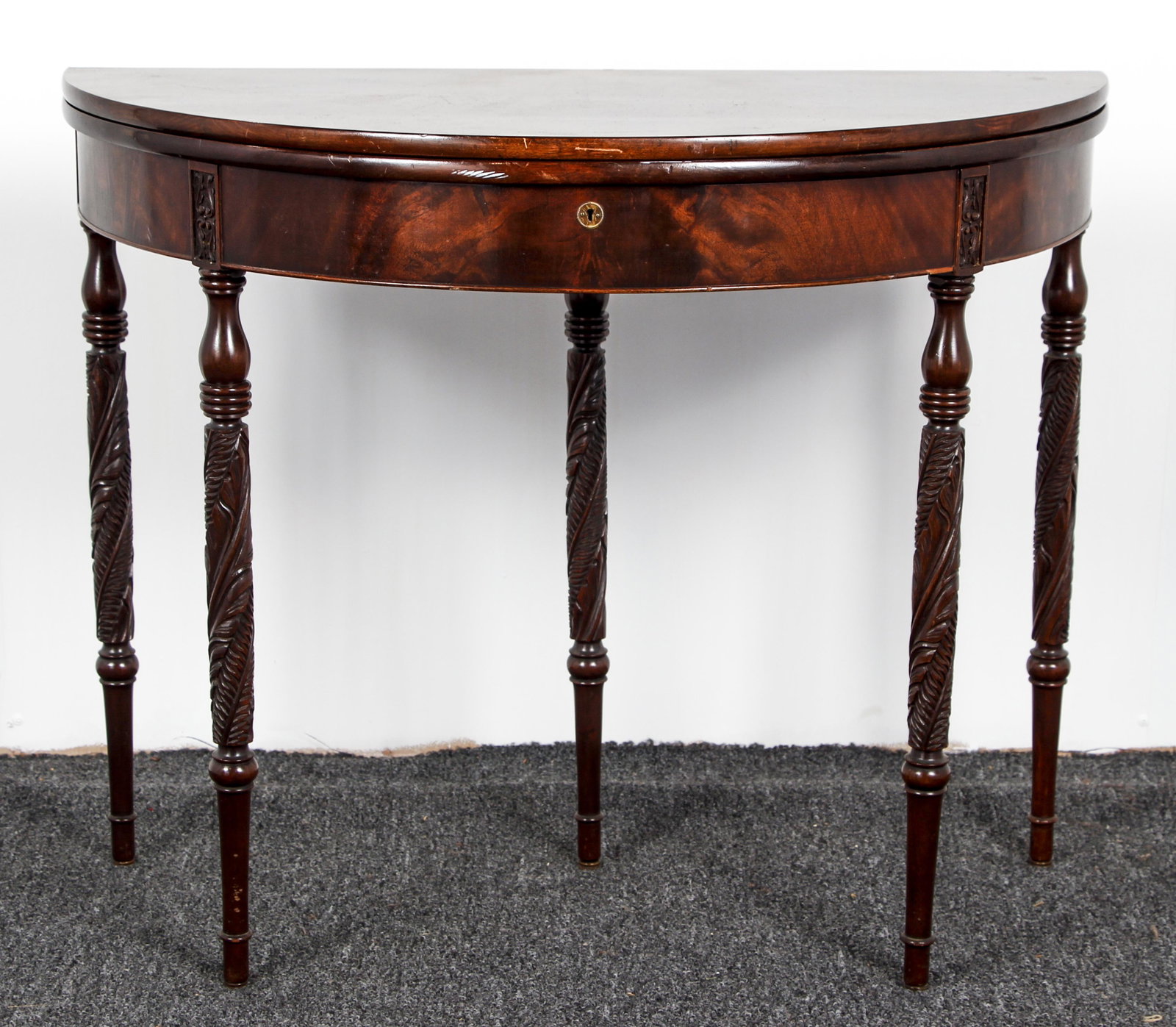 Circular Empire Mahogany Swing Leg Game Table: Empire Style Circular swing leg Game Table with fitted game interior, exceptional and delicately carved acanthus leaf decoration with tapering legs, 28.25 x 36 inches in diameter.